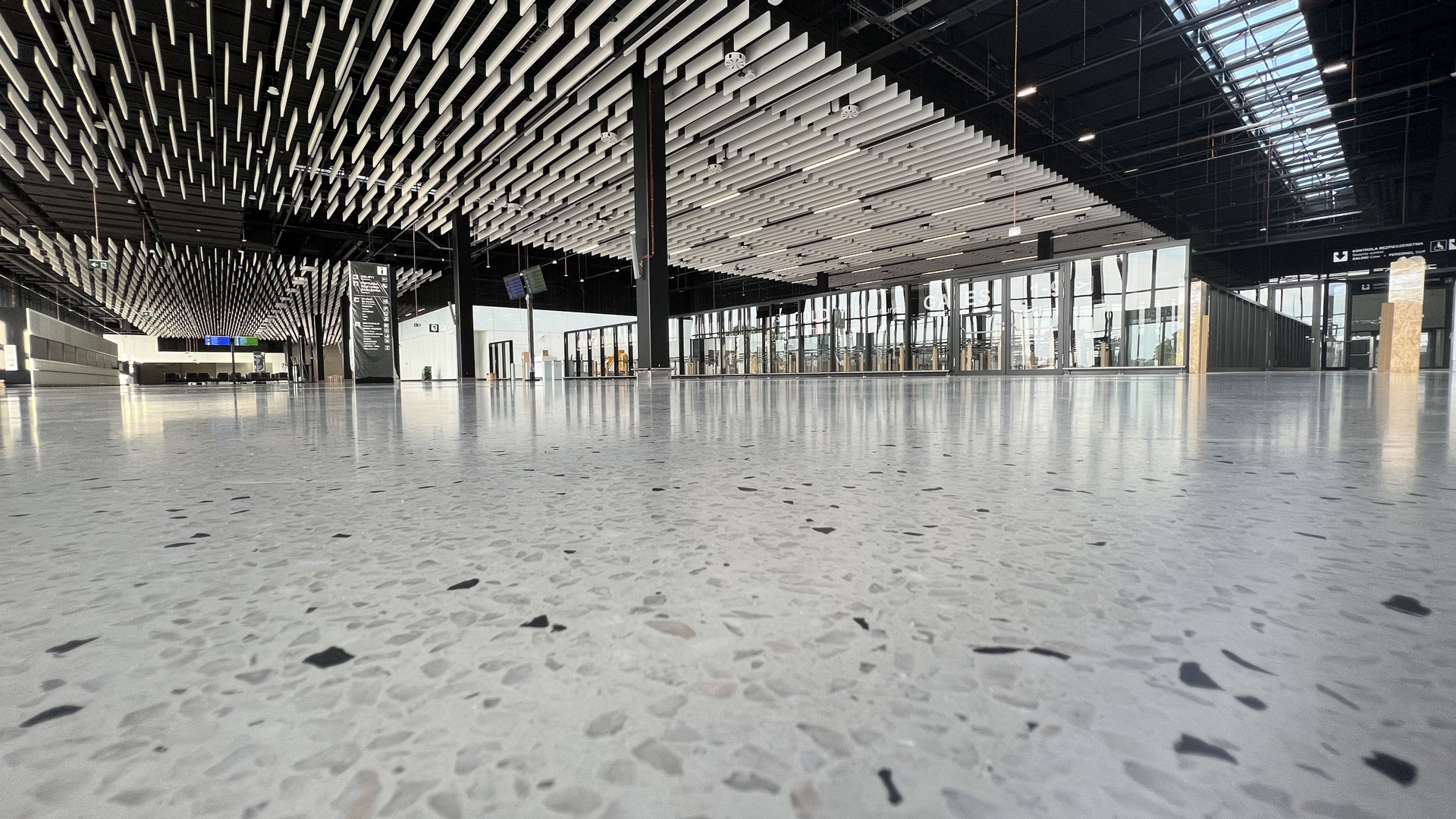 a large empty room with a large ceiling and windows
